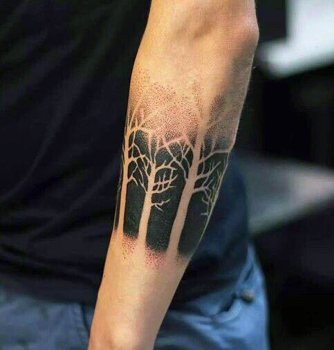Black dotwork negative space forest tattoo