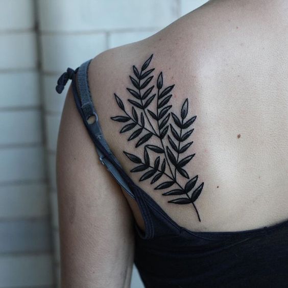 Black leaves tattoo on the left shoulder blade