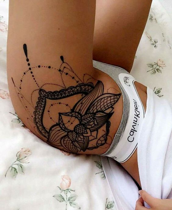 Black lotus flower tattoo on the left hip