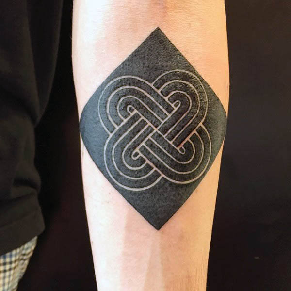 Black rhombus with negative space endless knot tattoo