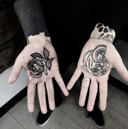 Black rose and panther tattoos on both palms