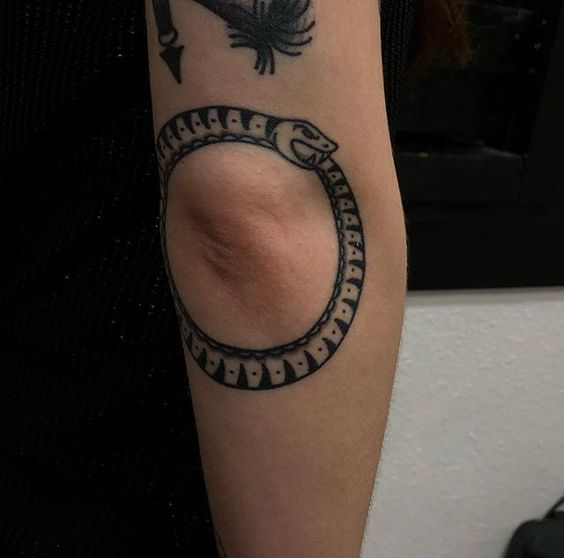 Black snake - ouroboros tattoo on the elbow