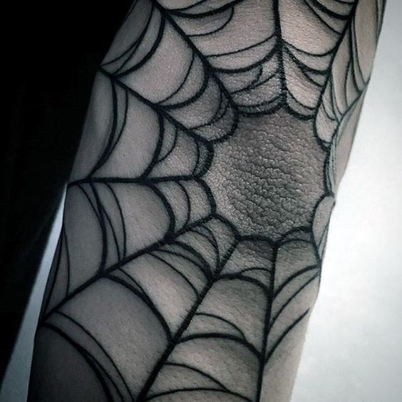 Black spider web tattoo on the elbow