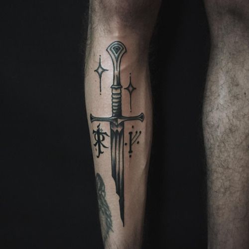 Black sword with runes on the righ shin