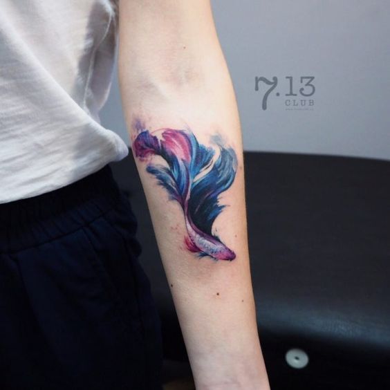 Blue pink and violet Betta fish tattoo on the arm