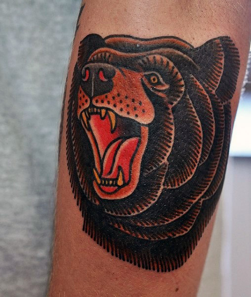 Brown bear tattoo on the arm
