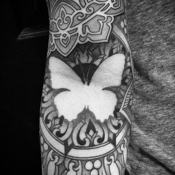 Butterfly negative space tattoo on the arm