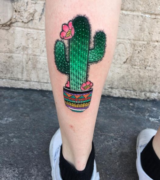Cactus in a colorful pot tattoo on the left calf