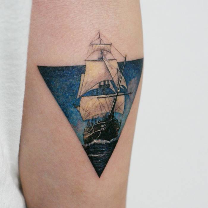 Carrack tattoo in a triangle sailing at night by tattooist doy