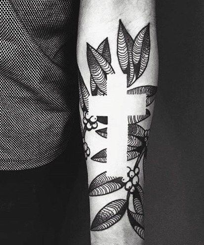 Cross and flowers negative space tattoo on the left arm