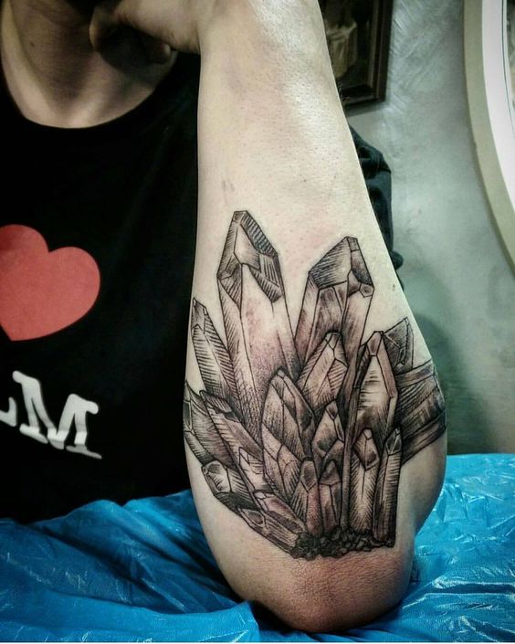 Crystal cluster tattoo on the left forearm