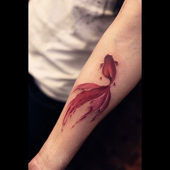 Cute goldfish tattoo on the left arm