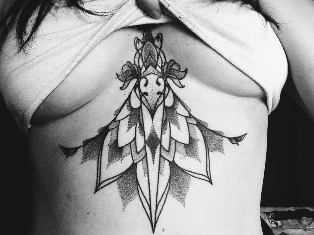 Dagger on the sternum and underboob mandala tattoo