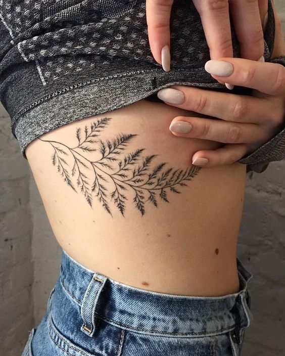 Delicate fern tattoo on the right rib cage by dasha sumkina
