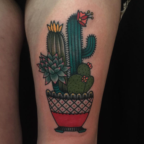 Different cactus species in a spanish style pot tattoo on the left thigh