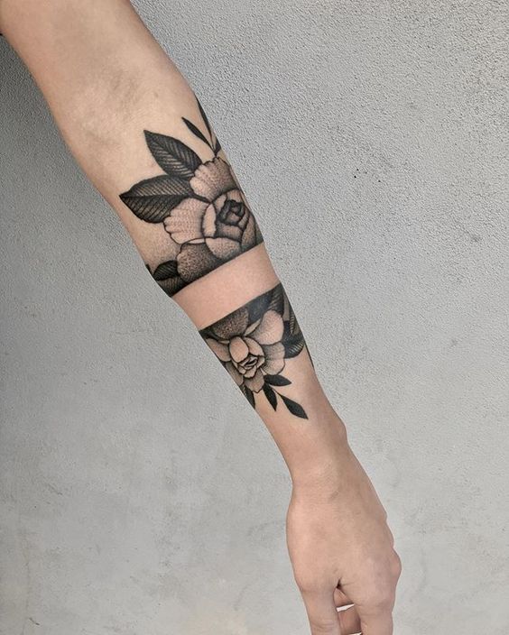 Dot work negative space flower tattoo on the arm