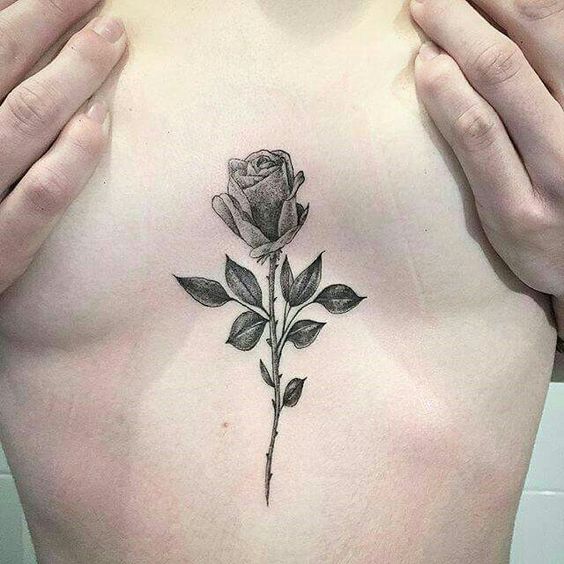 Dot work style black rose sternum tattoo