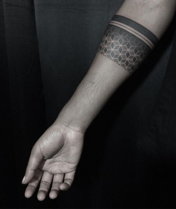 Dotwork tattoo of a black sacred geometry armband