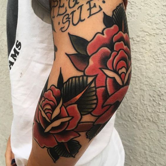 Double red rose tattoo on the left elbowjpg