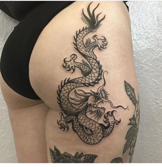 Dragon tattoo on the right booty side and the hip