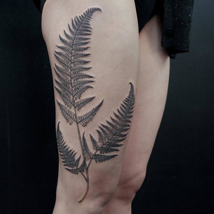 Excellent black fern tattoo on the right leg
