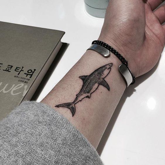 Excellent tattoo of a shark on the left inner wrist
