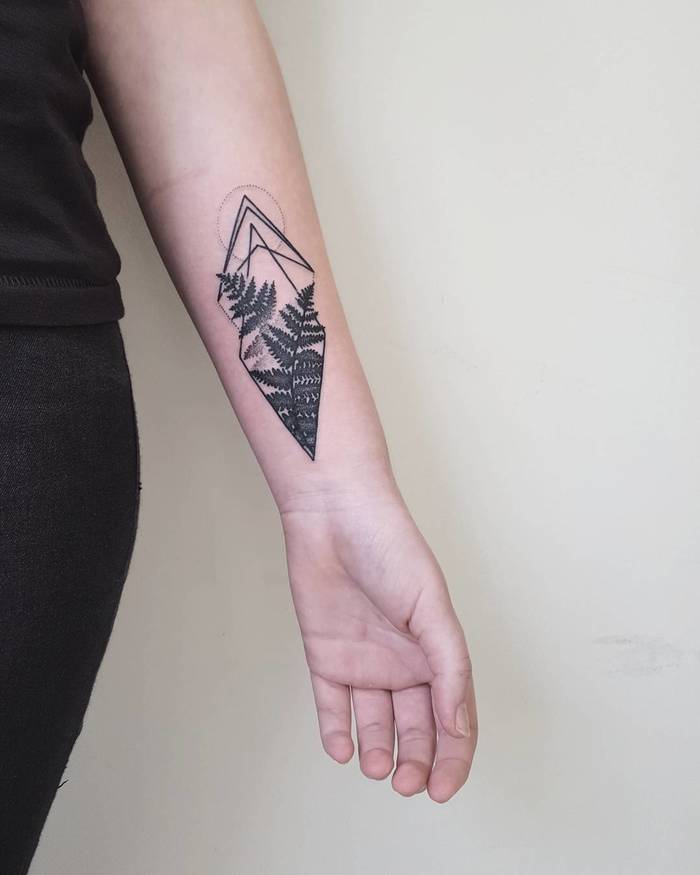 Fern leaf and rhombus tattoo on the left inner arm