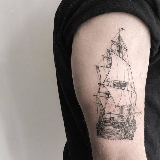 Fine line realistic tattoo of a ship on the right upper arm