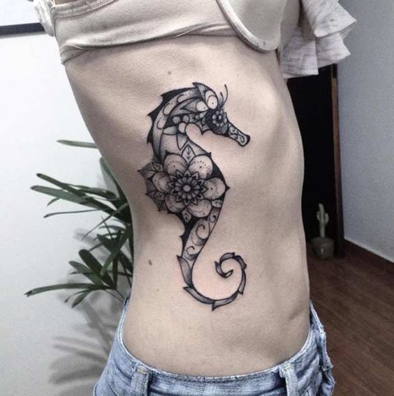 Floral black seahorse tattoo on the right side