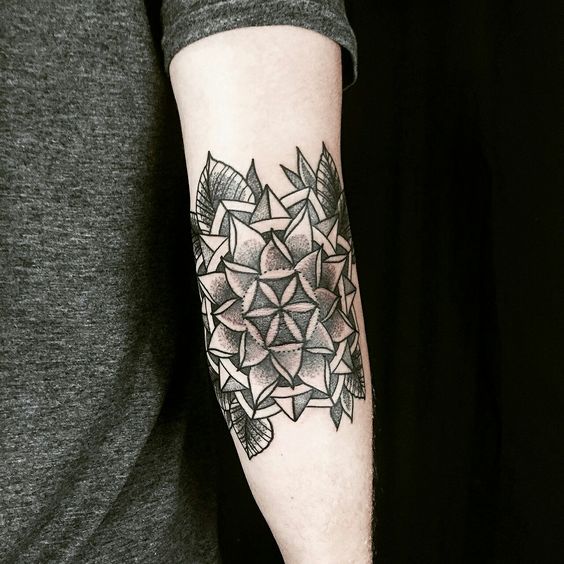 Floral mandala tattoo on the right elbow