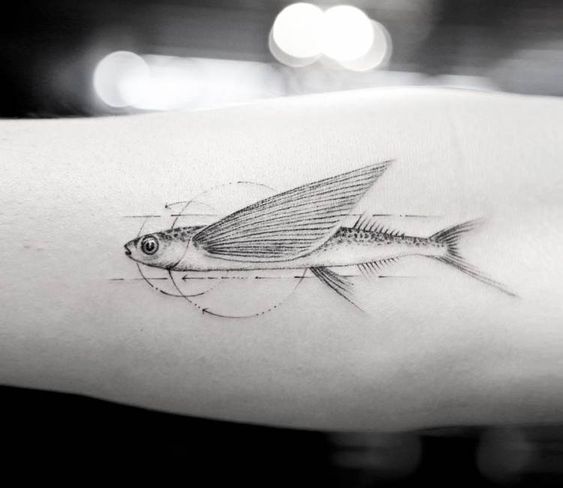 Flying fish tattoo on the arm by Mr K Tattoo
