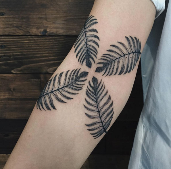 Four fern leaves tattoo on the right inner arm by sasha masiuk
