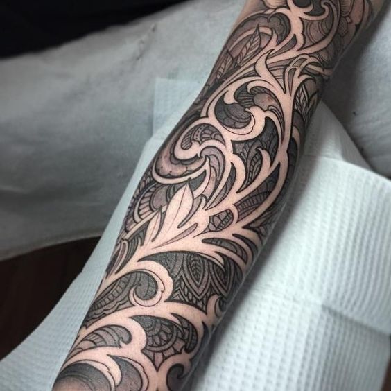 Full sleeve ornamental black negative space tattoo