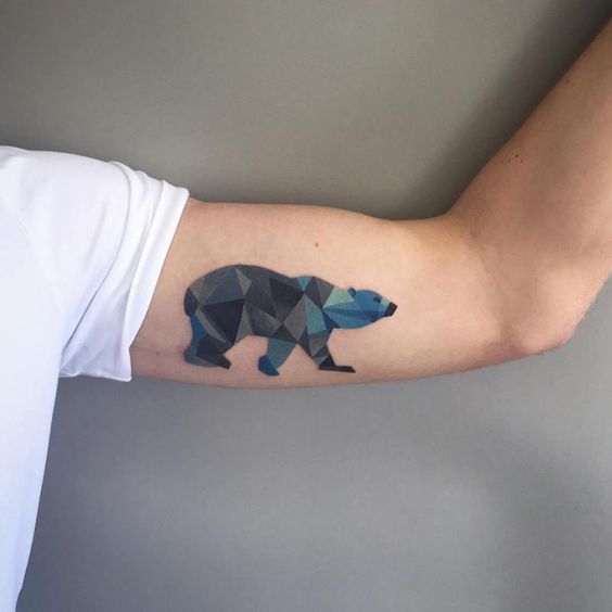 Geometric polar bear tattoo on the left bicep by sasha unisex