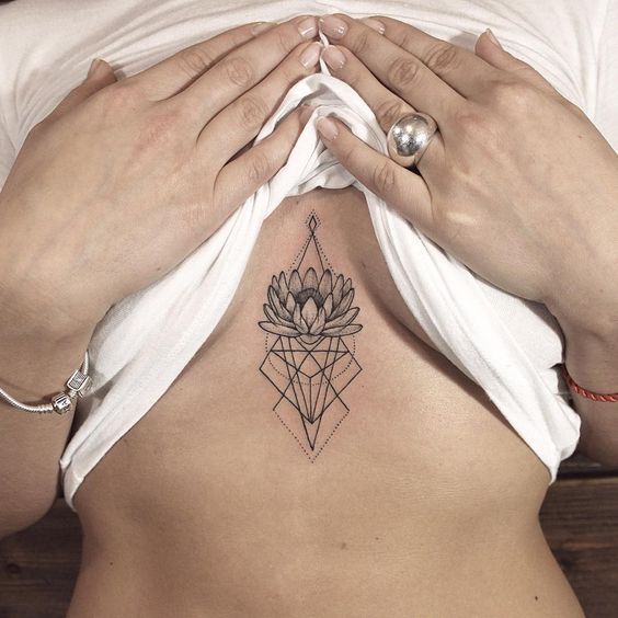 Geometric shapes and lotus flower sternum tattoo
