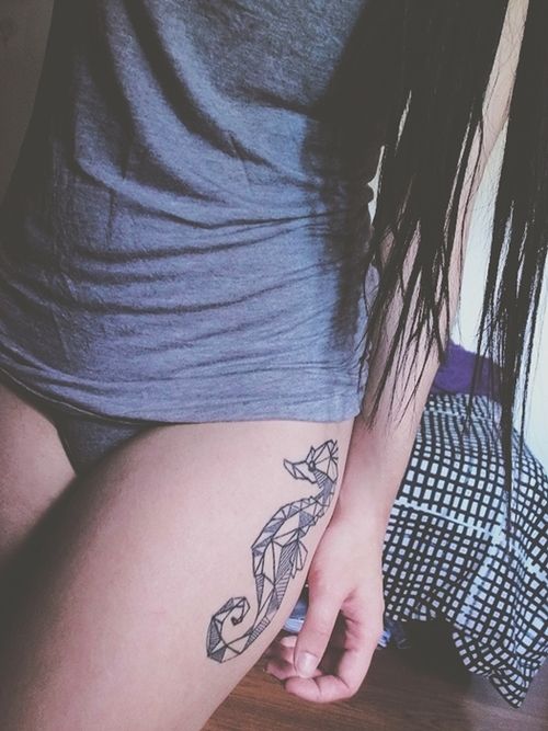 Geometric tattoo of a seahorse on the left hip