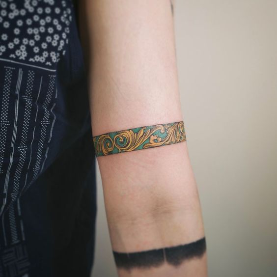 Gold and turqouise carved flowers armband tattoo