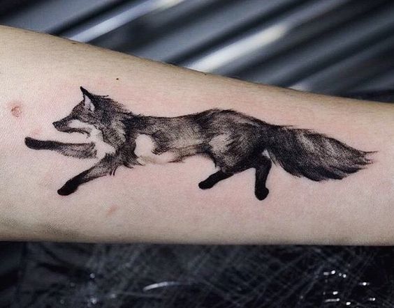 Grey and black running fox tattoo