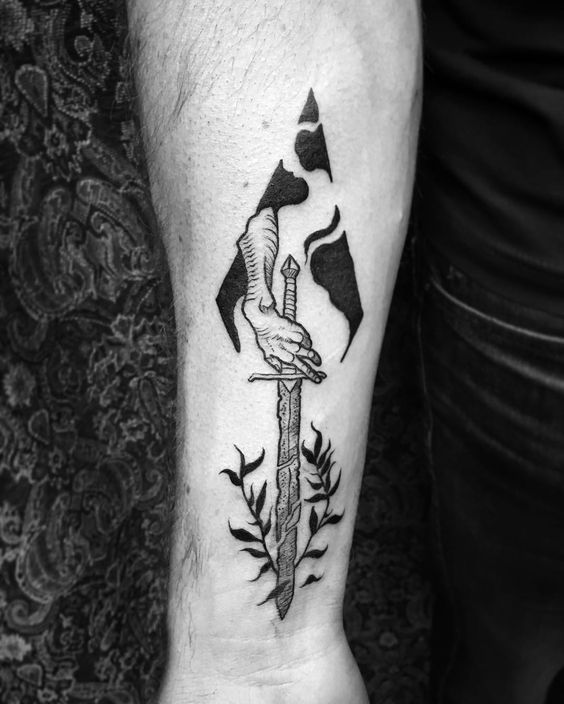 Hand holding a broken sword tattoo