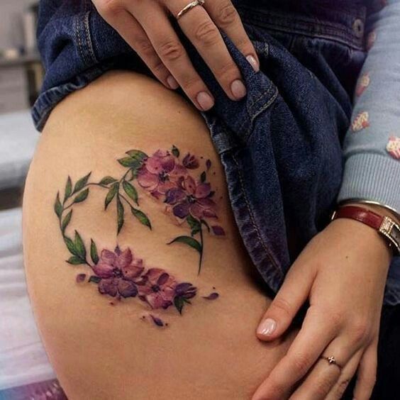 Heart shaped flower tattoo on the right hip