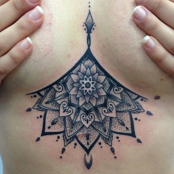 Incredible dot work black mandala sternum tattoo