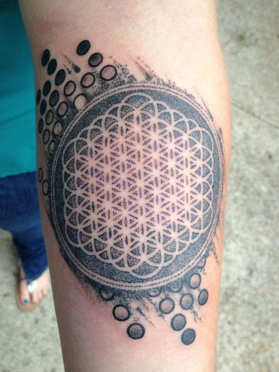 Incredibly dense black flower of life tattoo on the inner arm