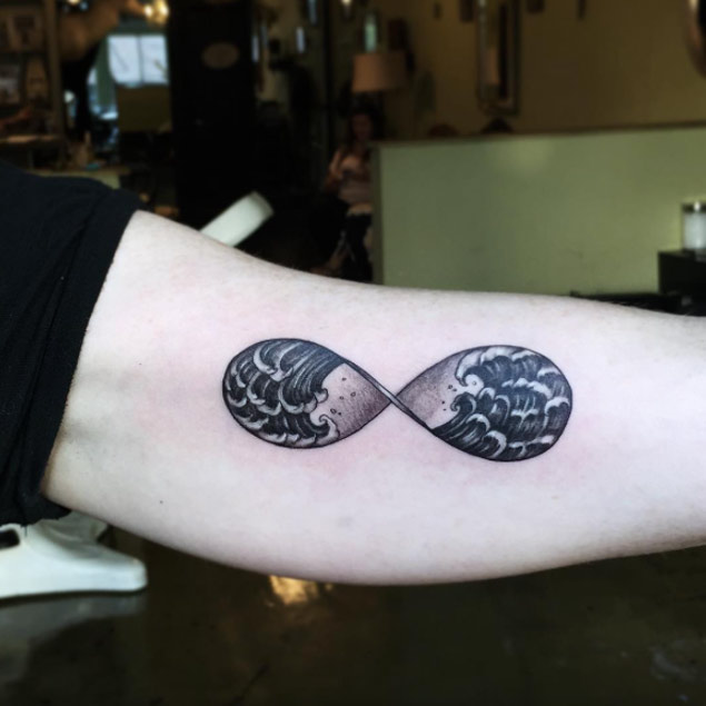 Infinite wave tattoo on the left bicep
