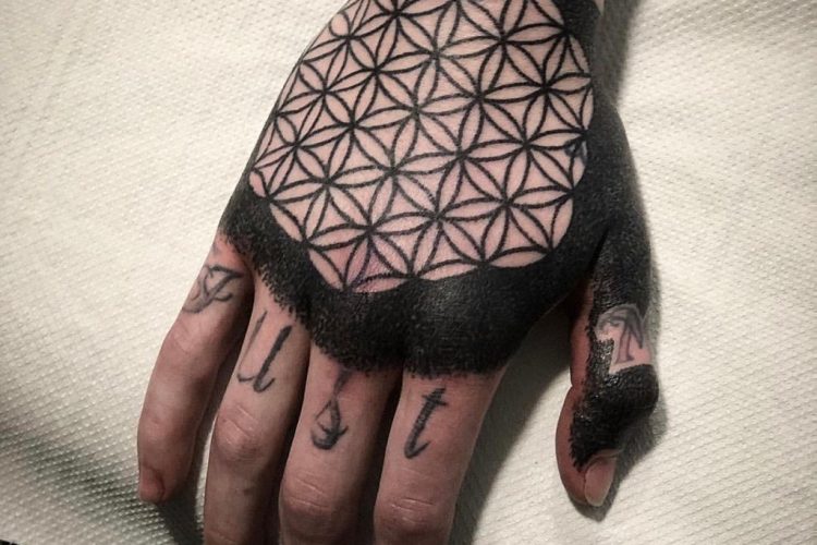 Intense black flower of life tattoo on the right hand