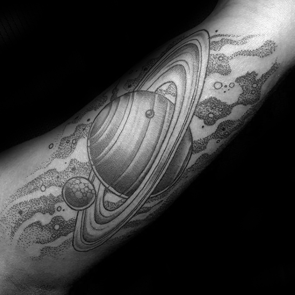 Large black dotwork tattoo of a saturn on the arm