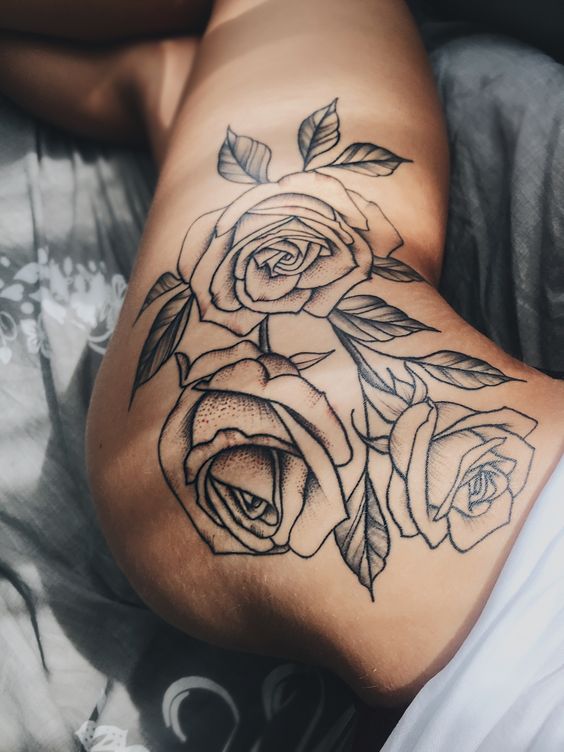 Large black outline roses tattoo on the left hip