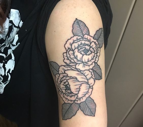 Linear tattoo of a black peony on the arm