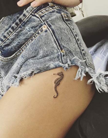 Little seahorse tattoo on the left upper thigh