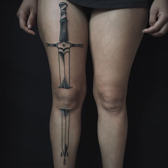 Long sword tattoo on the right leg