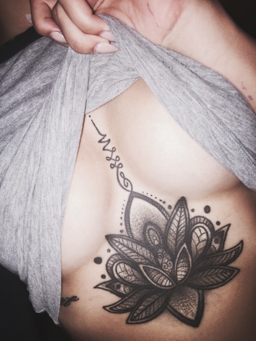 Lotus flower breastbone tattoo